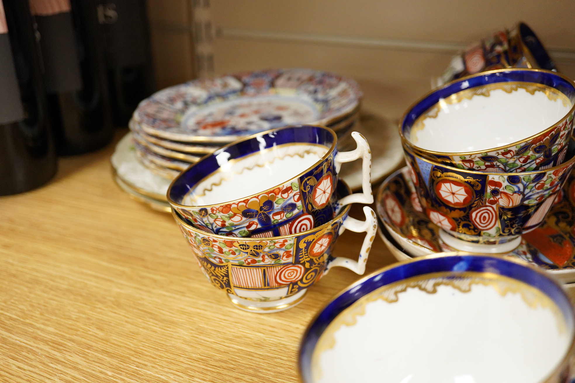 A 19th century Derby Imari pattern part tea set including a teapot a pair of 19th century botanical dishes and six small ironstone dishes.